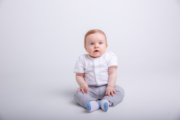 portrait of child smiling isolated on white background. baby boy sitting on a white background