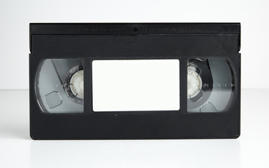 an Old retro vhs tape with a blank label for mock up, typography or graphics isolated on a white background. nostalgic 1980s music video cassette. obsolete media format.