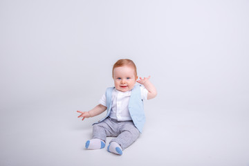 baby boy sitting on a white background