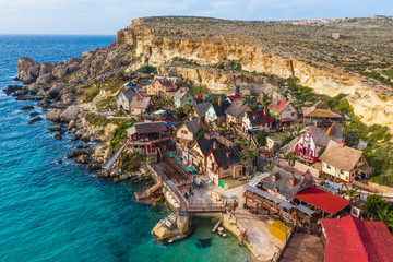 Aerial view of famous tourist attraction Popeye village, also known as Sweethaven village. Sunny...