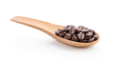 roasted coffee beans in wood spoon isolated on white background