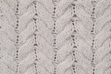 Beautiful beige knitted texture for background. White winter backdrop. Space for text.
