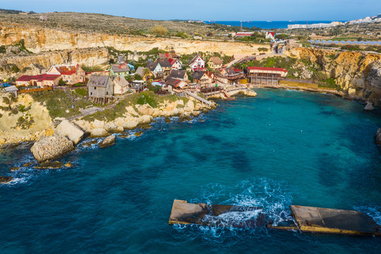 Top view of famous tourist attraction Popeye village, also known as Sweethaven village. Sunny day, blue sea. Mellieha city. Malta country