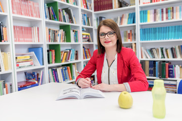 Girl in library reading and studying