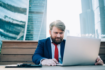 Confident freelancer working on project in business district