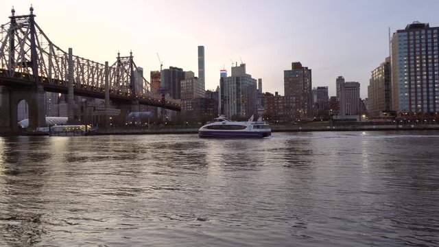 NEW YORK CITY, USA - NOVEMBER 30, 2019 : Cruise ship in East river near Queensbridge park in the evening