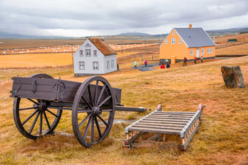 Fototapeta premium Agricultural cart and countryside homes in Iceland
