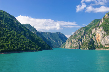 Fototapeta na wymiar Aerial photo of Piva Lake in Montenegro. Road above Piva Lake (Pivsko Jezero). Montenegro, Pluzine, Lake of Piva, Mratinje Dam.