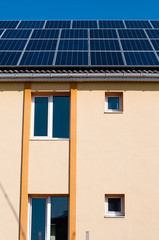 Solar panel system on house roof, sunny blue sky background.Blue solar panels
