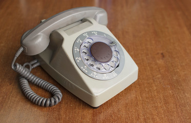 Vintage old telephone on wooden desk