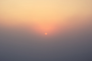 Vintage style photo of morning sun through foggy sky