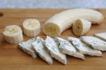 Soft cheese pieces and banana pieces ready to eat for breakfast side view