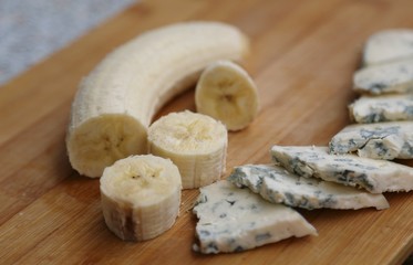 Soft cheese pieces and banana pieces ready to eat for breakfast side view