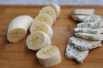 Cheese with green carvings cut with pieces on wood board  ready to eat.