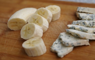 Cut cheese with mold and skin-free banana pieces ready to eat.
