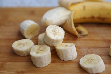 Cut cheese with mold and skin-free banana pieces ready to eat and banana yellow in skin