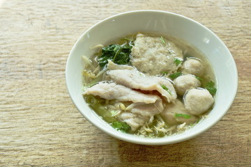 boiled soft slice pork and ball in clear soup on bowl