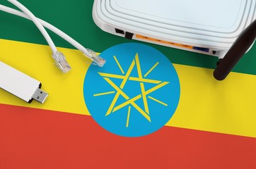 Ethiopia flag depicted on table with internet rj45 cable, wireless usb wifi adapter and router....