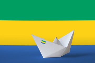 Gabon flag depicted on paper origami ship closeup. Handmade arts concept