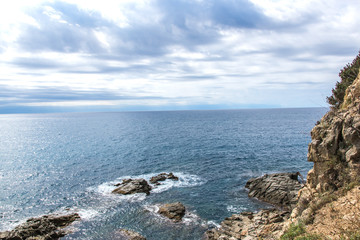 Fototapeta na wymiar Much stones in water in the sea in Spain.