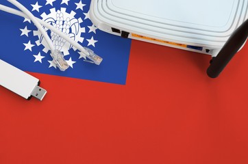 Myanmar flag depicted on table with internet rj45 cable, wireless usb wifi adapter and router....