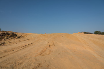 Yellow sandy slope pavement with sky landscape