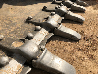 Close up of crawler bulldozer bucket teeth. Earthmoving heavy machinery on the road construction...