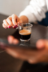 Girl drinking a coffe with phone