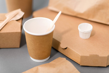package, recycling and eating concept - disposable paper containers for takeaway food on table