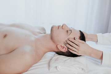 male masseuse makes a therapeutic massage Spa