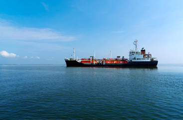 Red Liquefied Petroleum Gas LPG tanker in the sea out of the port in gulf of Thailand. Cargo ship against blue ocean.