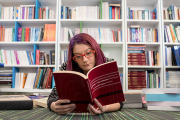 Girl in library posing, reading and studying