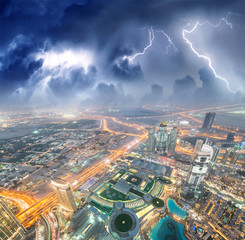 Dubai panoramic skyline and buildings at night with storm approaching