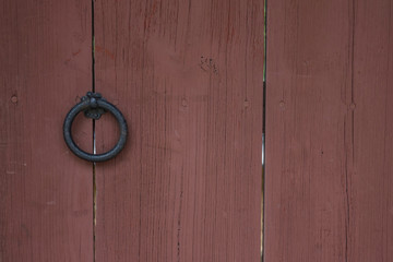 Brown door with an antique handle.
