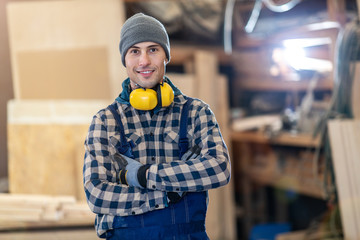 Young male worker in timber warehouse 