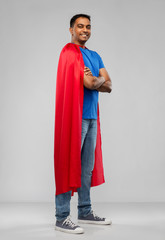Fototapeta premium super power and people concept - happy smiling indian man in red superhero cape with crossed arms over grey background