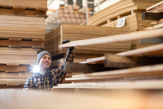 Young male worker in timber warehouse 
