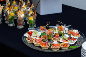 Salmon rolls stuffed with cheese sprinkled sesame seeds