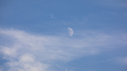 daytime sky landscape with white clouds and moon