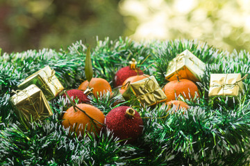 Fototapeta na wymiar Christmas balls, gift boxes and tangerines