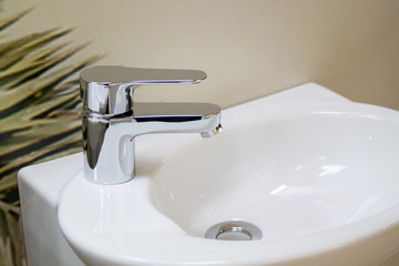 close up view of chrome faucet and white sink in bathroom