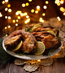 Christmas carp, Fried carp fish slices on a ceramic plate on the holiday table, close up. Traditional christmas eve dish. Polish Christmas