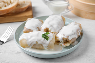 Delicious cabbage rolls served on white wooden table