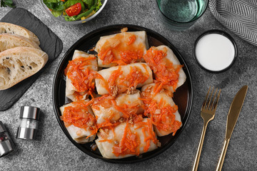 Delicious cabbage rolls served on grey table, flat lay