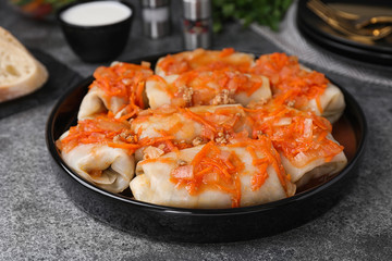 Delicious cabbage rolls served on grey table, closeup