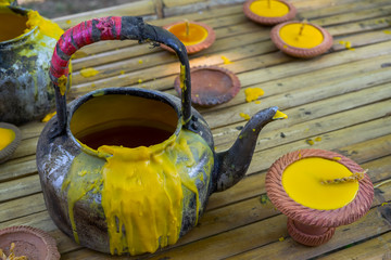 Beeswax Kettle and lamp was placed in bamboo bench for use as a candle casting device In the Buddhist tradition for offering to monks during the rainy season in Thailand