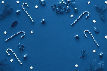 Monochrome blue color Xmas background with copy-space. Trendy geometric Christmas flat lay on paper...
