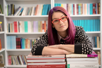 Girl in library posing, reading and studying