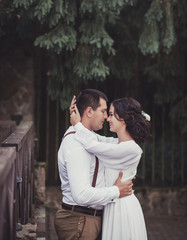 Beautiful young wedding couple hugging. Bride and groom in boho style