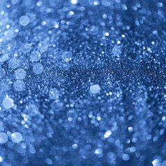 Holiday abstract texture. Christmas card with copy space. ?lassic blue background bokeh, defocused lights.
